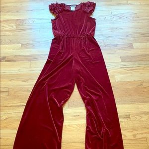 A kids red velvet jumpsuit.